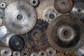 Old circular saw blades and emery wheels on wooden table, closeup, top view. Carpentry tools, sawing and grinding equipment Royalty Free Stock Photo