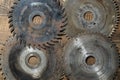 Old circular saw blades on wooden table, closeup, top view. Carpentry tools, sawing equipment Royalty Free Stock Photo