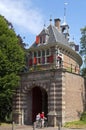 Old City gate Oosterpoort in Hoorn and reading man