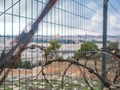 The Old City of Jerusalem seen through coils of razor wire Royalty Free Stock Photo