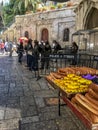 Old City of Jerusalem with view of Police keeping watch and food stand with sweet and savory breads, while tourists explore