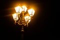 Old city lantern in the night. Old fashioned streetlight close up.