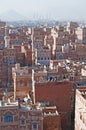 The Old City of Sana'a, decorated houses, palace, minarets and the Saleh Mosque in the fog, Yemen Royalty Free Stock Photo