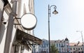 Old city signboard mockup. Downtown in sunshine with classic building and lantern. Board of round shape on cafe, hotel Royalty Free Stock Photo