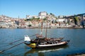 Old city view and riverboats full of wooden barrels with port wine, old boats from local wineries