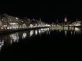Old city of Zurich with Christmas decorations and illuminations mirroring in the Limmat River