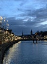 Old city of Zurich with Christmas decorations and illuminations mirroring in the Limmat River sowing the left bank Royalty Free Stock Photo