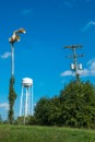 Old civil defense siren, old water tower and utility pole/old in Royalty Free Stock Photo