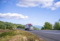 Classic blue big rig semi truck transporting frozen food in refrigerator semi trailer running on the road in Columbia Gorge area Royalty Free Stock Photo