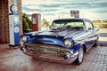 Old, Classic American Chevy Car And Old-Fashioned Chevron Gas Pumps Royalty Free Stock Photo