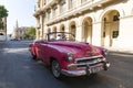 Old classic american red car on the background of National Capitol Building in Havana, Cuba Royalty Free Stock Photo
