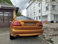 Old elegant veteran classic saffron pearl metallic coupe car Volvo C70 parked