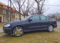 Old classic black Nissan Almera sedan car parked