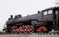 Old classic black steam locomotive with red decoration on railroad track Royalty Free Stock Photo