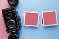 Old classic camera, lens and paper photo frame with empty space for content on pastel color background Royalty Free Stock Photo