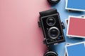 Old classic camera, lens and paper photo frame with empty space for content on pastel color background Royalty Free Stock Photo