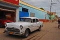 Old classic yank tank Cuban car parked on a side street in Trinidad, Cuba
