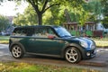 Old classic dark greeny Mini Cooper second version parked