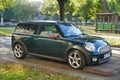 Old classic dark greeny Mini Cooper second version parked Royalty Free Stock Photo