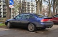 Old classic dirty sedan car Mazda 626 parked