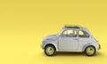 Old classic italian car 500 gray on a yellow background