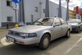 Old classic Japanese sedan car Nissan Maxima parked