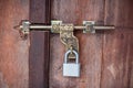 An old classic metal padlock on a vintage door of a house