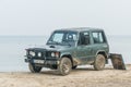 Old classic Mitsubishi Pajero 4WD car parked on a beach