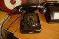 Old classic phone with rotary dial on a wooden table Royalty Free Stock Photo