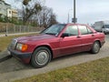 Old classic purple red car Mercedes Benz 190 1.8 parked