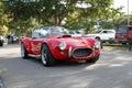 Old classic red sports car driven on road Royalty Free Stock Photo