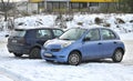 Old classic small cheap popular blue compact car Nissan Micra parked left side view Royalty Free Stock Photo