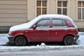 Old classic small cheap popular veteran red compact car Nissan Micra parked left side view Royalty Free Stock Photo