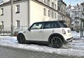 Old classic small supermini subcompact car white Mini Cooper parked in snow Royalty Free Stock Photo