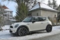 Old classic small supermini subcompact car white Mini Cooper parked in snow Royalty Free Stock Photo