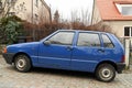 Old classic small veteran Italian popular blue Fiat Uno Fire 1.0 I.e.s parked