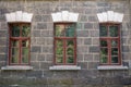 An old classic stone house with windows. Calssic stone walls and windows textures.