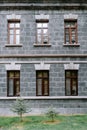 An old classic stone house with windows. Calssic stone walls and windows textures.