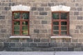 An old classic stone house with windows. Calssic stone walls and windows textures.