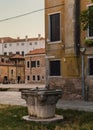 Old venetian fountain and brick buildings in Venice, Italy Royalty Free Stock Photo