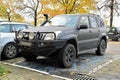 Old classic veteran black offroad big 4wd car Toyota Landcruiser with long exhaustion pipe parked