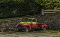 Old classic veteran car with silver red yellow colors and stone wall