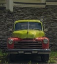 Old classic veteran car with silver red yellow colors and stone wall Royalty Free Stock Photo