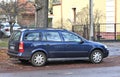 Old classic veteran dented dark blue German hatchback kombi car Opel Astra parked