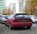 Old classic veteran dented red coupe car Honda Civic parked Royalty Free Stock Photo