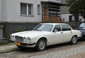 Old classic veteran ebony white Jaguar V12 Sovereign sedan executive parked