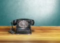 Old classic vintage dial telephone on wooden table