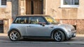 Old classic silver grey Mini Cooper parked