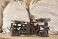 Old classic vintage trade scale on wooden table with bags on background