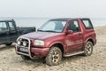 Old classic 4WD car Suzuki Vitara parked on a beach